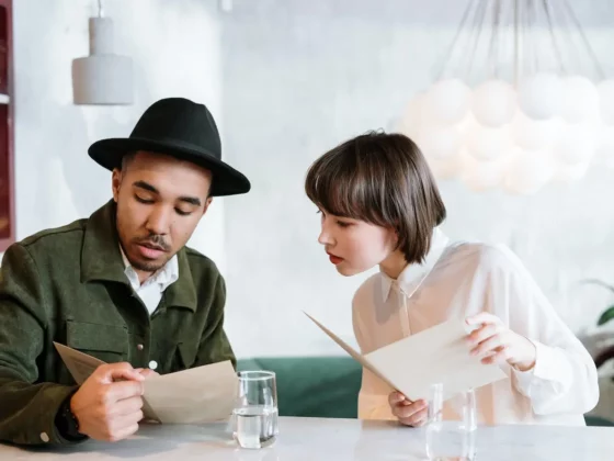 two people looking at a menu in a cafe
