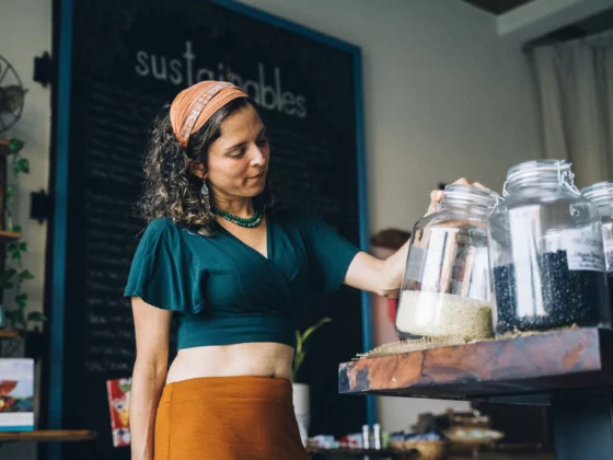 woman looking at a jar in a cafe