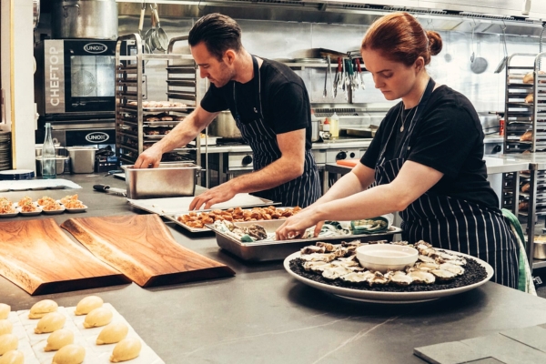 two caterers prepping food