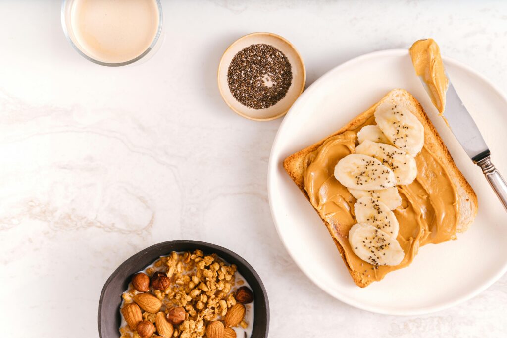 Image showing nuts in different forms including peanut butter on toast and granola with milk.